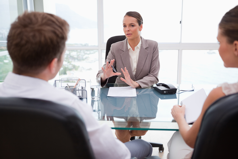 Lawyer explaining legal situation to her clients Lawyer explaining legal situation to her clients